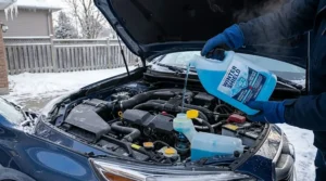 Graphic illustration detailing how to open a car hood and locate the blue windshield washer fluid reservoir cap with the wiper symbol to add winter windshield washer fluid -40.