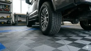 Resilient modular garage tiles supporting a vehicle, showing high-impact strength.