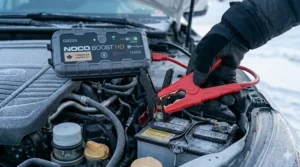 Portable jump starter featuring built-in LED flashlight for night-time battery emergencies.